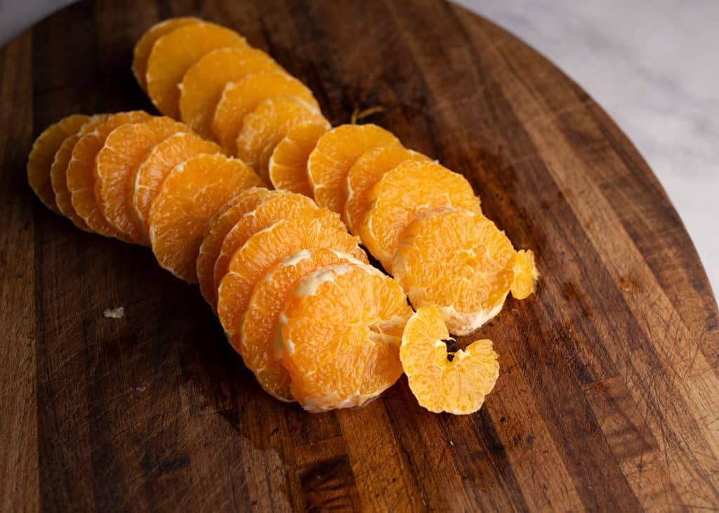 Peeled and pithed orange slices on the cutting board