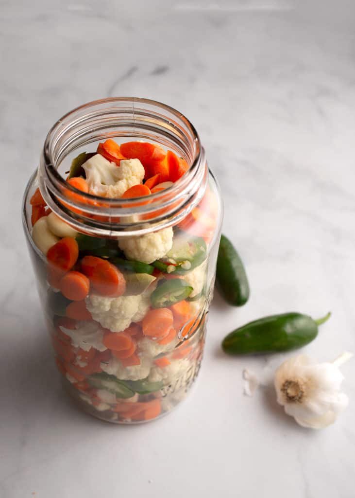 Vegetables all layered into a large jar