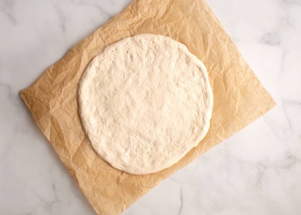 Pizza dough pressed out into a circle