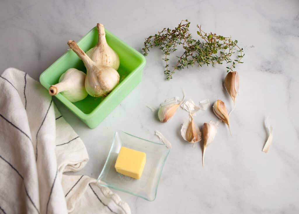 Garlic in a jadeite dish, fresh thyme, garlic, and butter