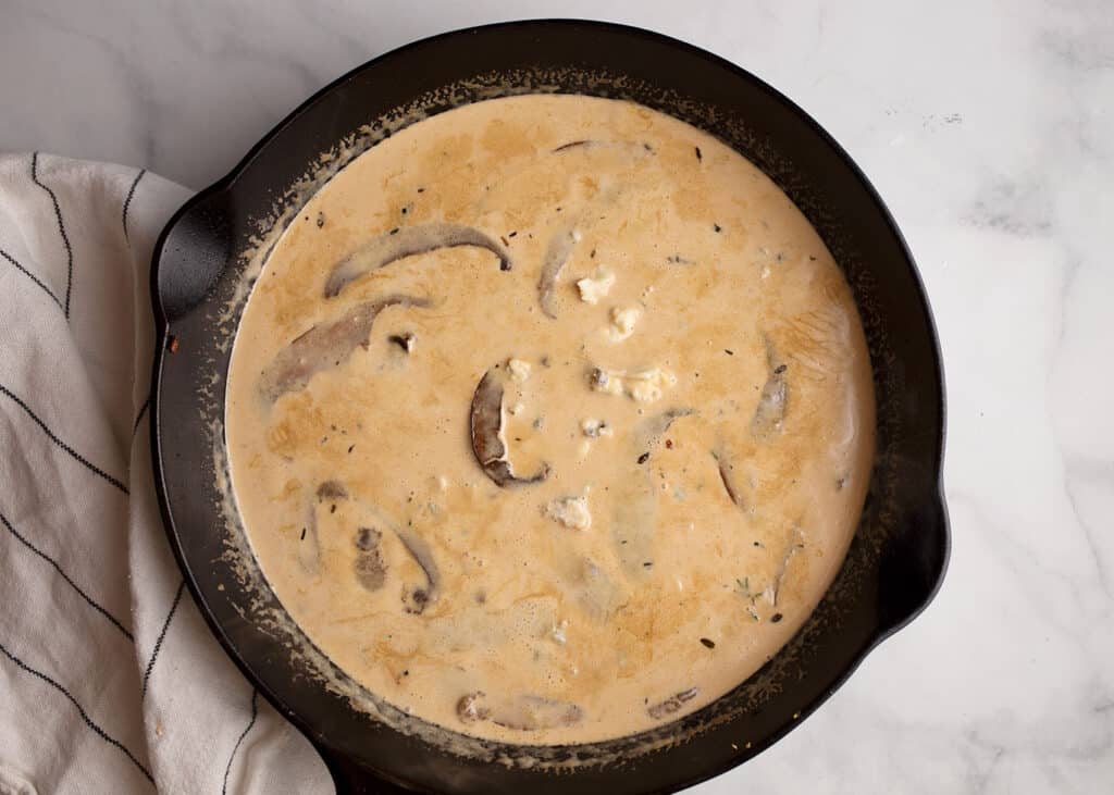 Gorgonzola Cream Sauce with portobello mushrooms in a cast-iron skillet