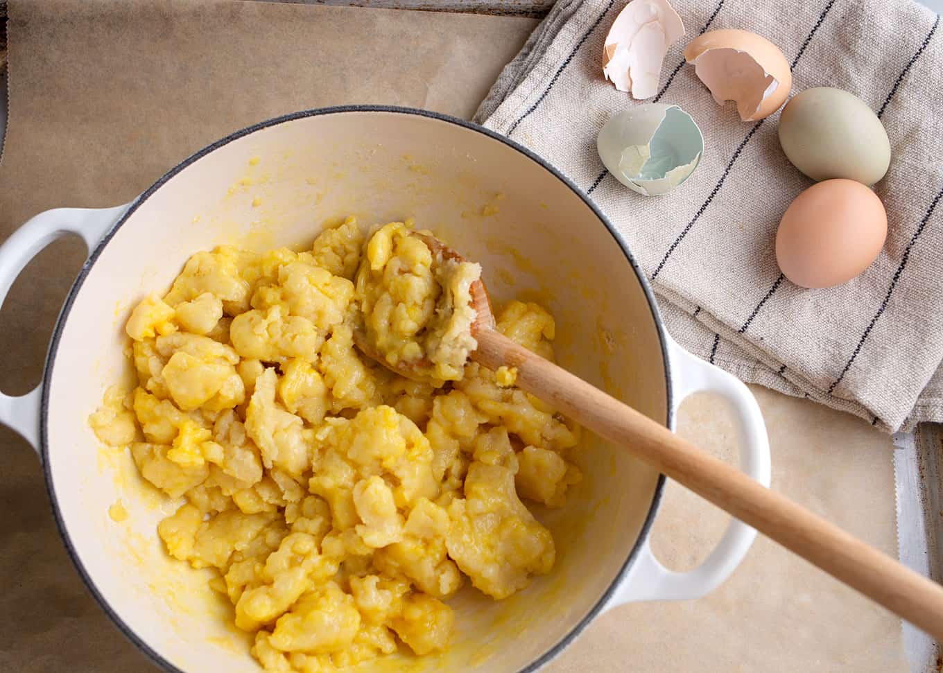 Mixing the eggs into the dough in the Dutch oven one at a time