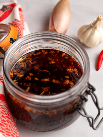Close up view of opened glass jar of Chili Crisp
