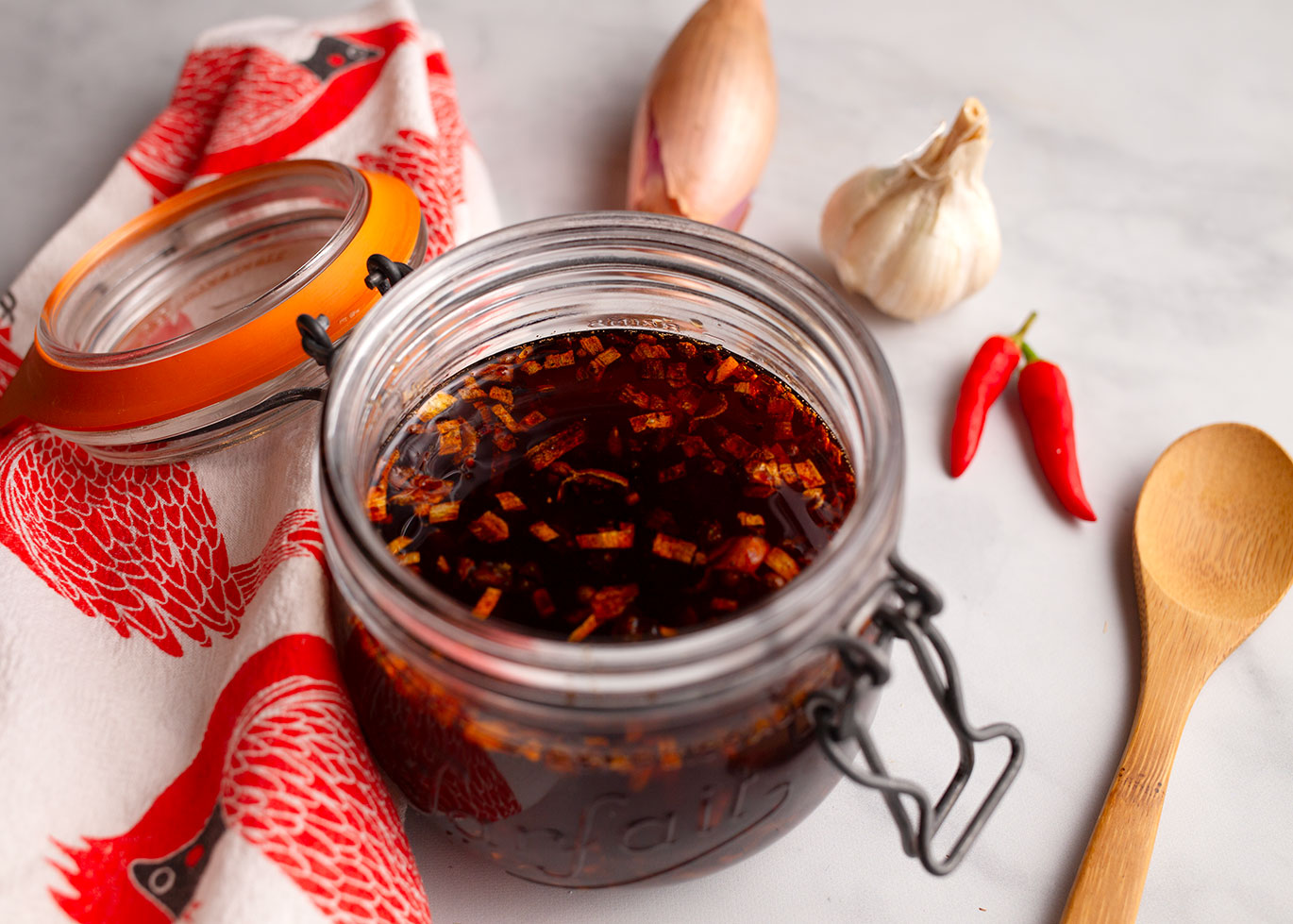 Fresh chili crisp in a glass storage jar.