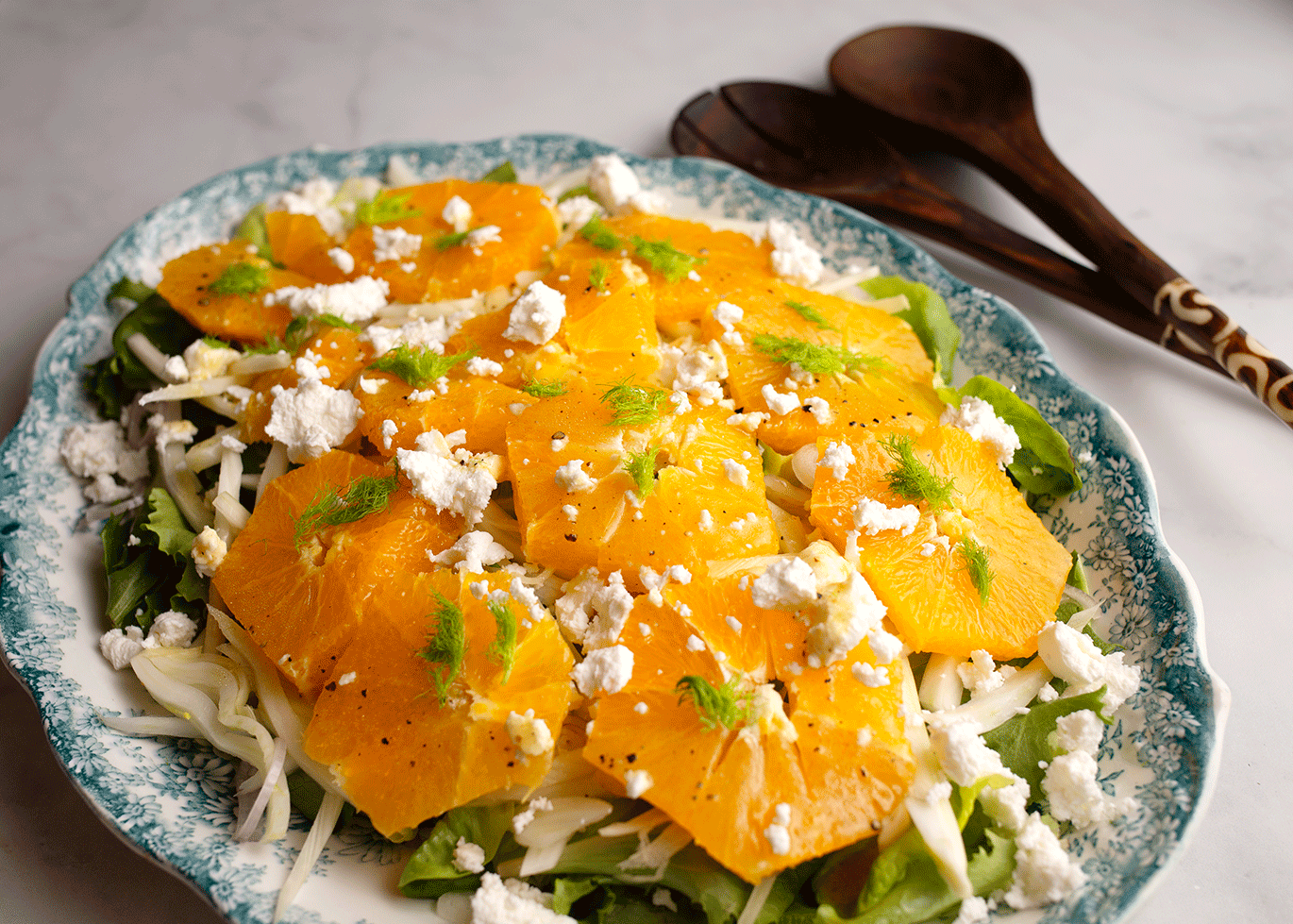 Close up photo of the finished salad with the servers.
