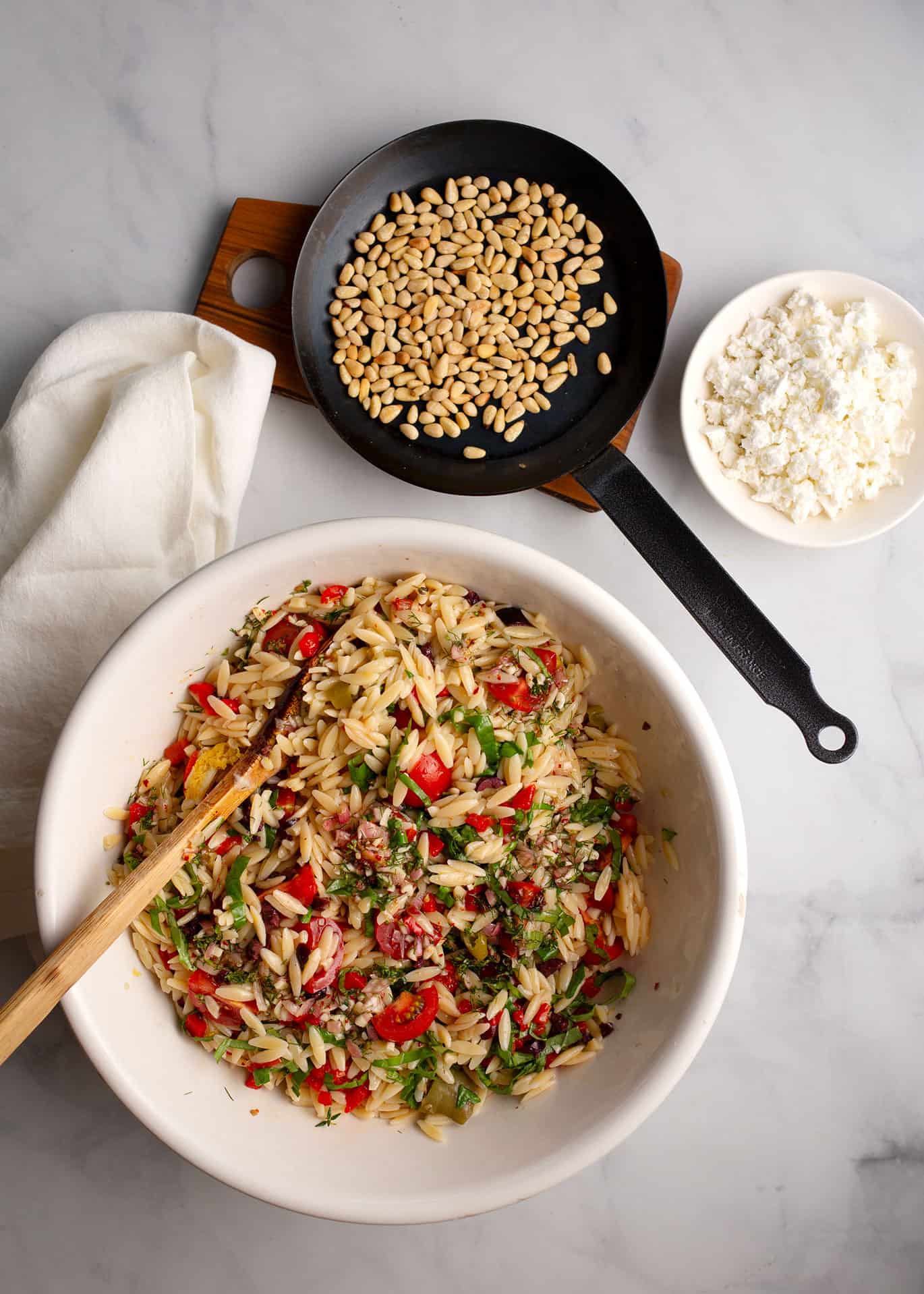 Toasted pine nuts and feta cheese are the last ingredients to add