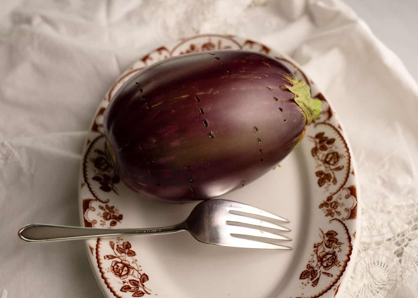 Pierce the eggplant with a fork or the tip of a knife.