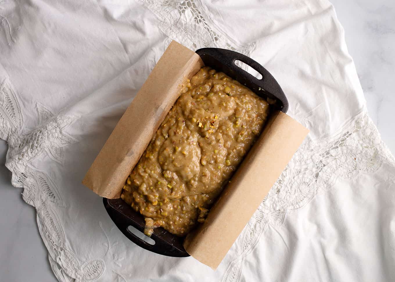 Line the loaf pan with parchment paper and spread the batter in evenly.