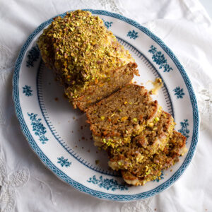 Sweet Eggplant & Pistachio Quick Bread on a blue transferware platter