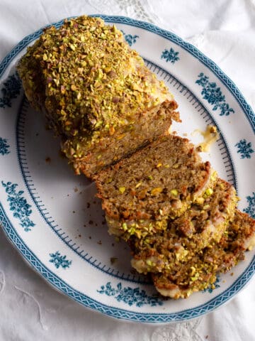 Sweet Eggplant & Pistachio Quick Bread on a blue transferware platter